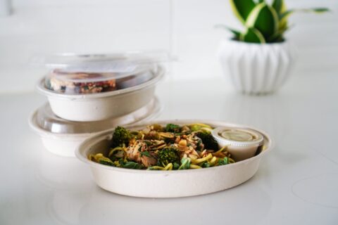 A nutritious takeout meal featuring broccoli and seeds, neatly packaged for convenience.