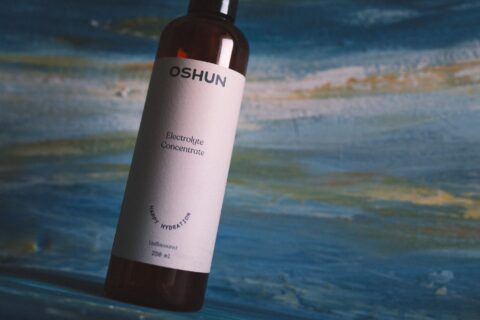 Close-up of Oshun electrolyte concentrate against a textured background.