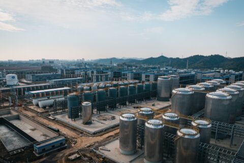 Expansive aerial view of an industrial complex with storage tanks, located in China.